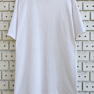 May include: White t-shirt with a crew neck and short sleeves. The shirt is made of a soft, comfortable material.