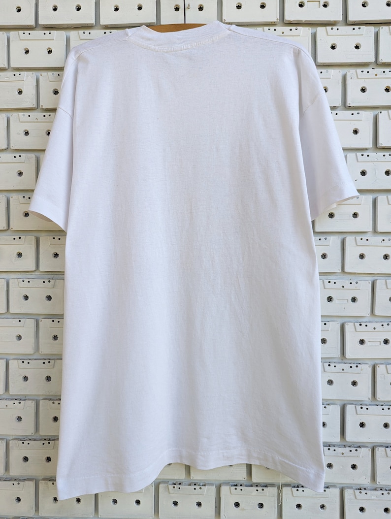 May include: White t-shirt with a crew neck and short sleeves. The shirt is made of a soft, comfortable material.