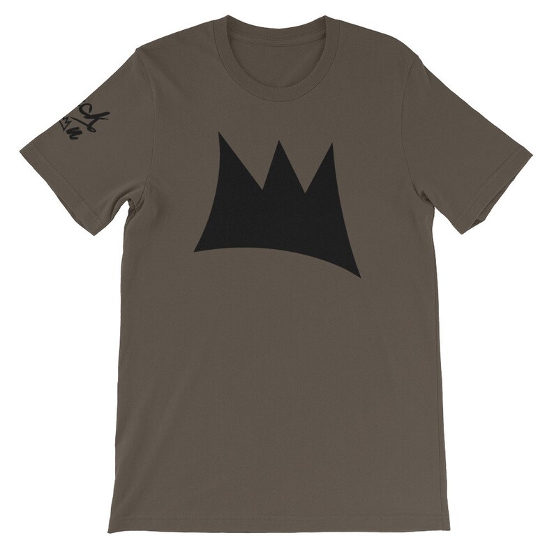 May include: A short-sleeved, olive-green t-shirt featuring a large black crown graphic on the front. The sleeve has the text "Black Crown" printed in black. The shirt is made of a soft material.