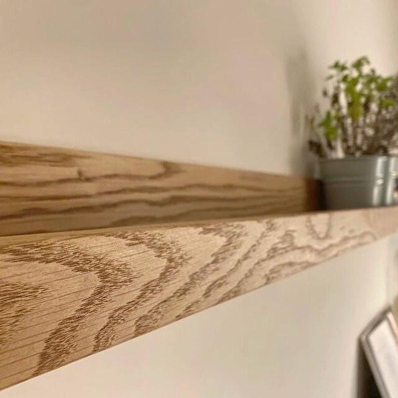 close up of oak shelf, with interesting grain pattern and plants on shelf.