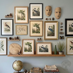 Home office oak shelf, with wall art and nature photos on a soft blue wall.