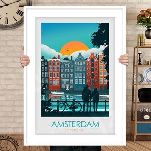 May include: A colorful illustration of Amsterdam, Netherlands, with a couple standing on a bridge overlooking a canal with a bicycle. The illustration features a sunset with a bright orange sun and a blue sky with white clouds. The buildings are red, orange, yellow, and blue. The text "AMSTERDAM" and "NETHERLANDS" is printed below the illustration.