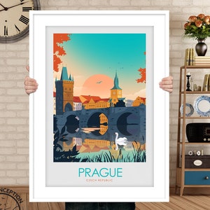 May include: A colorful illustration of Charles Bridge in Prague, Czech Republic. The bridge is depicted with a reflection in the water below. A white swan is swimming in the water. The text "PRAGUE" and "CZECH REPUBLIC" is printed below the image.