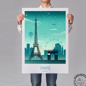 May include: A teal and blue poster with a silhouette of the Eiffel Tower and the Arc de Triomphe in Paris, France. The poster also features a hot air balloon, a Ferris wheel, and a plane in the sky. The text "PARIS FRANCE" is at the bottom of the poster.