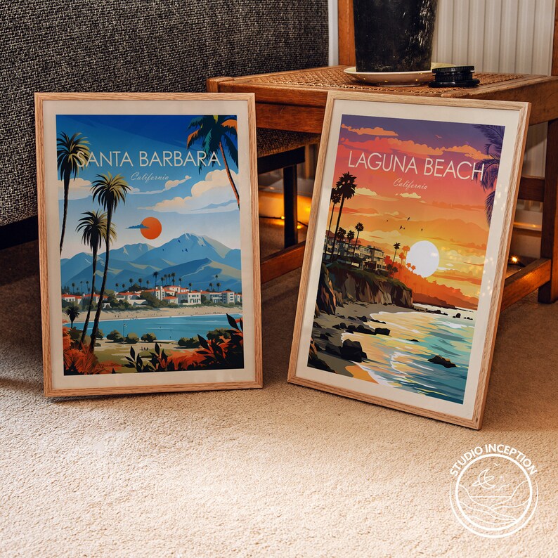 May include: Two framed prints of vintage travel posters. The left poster features a sunset scene of Santa Barbara, California. The right poster features a sunset scene of Laguna Beach, California.