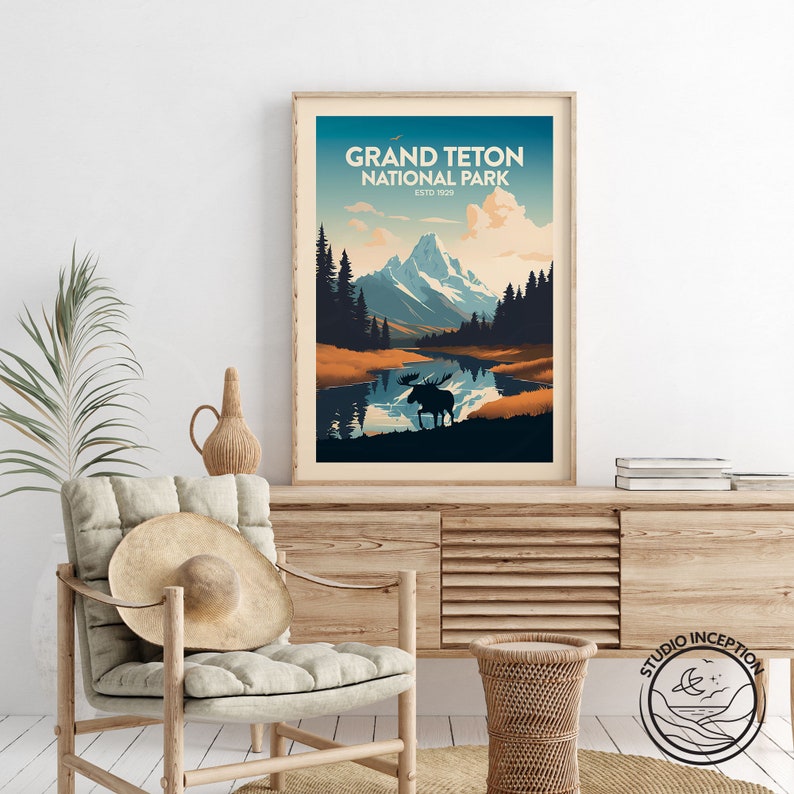 May include: A vintage-style poster with a blue, green, and brown color scheme depicting a mountain range with a lake in the foreground. The text "Grand Teton National Park Est'd 1929" is at the top of the poster. A silhouette of a moose is standing in the lake.