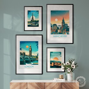 May include: Four framed city skyline prints with a minimalist design. The prints feature the cities of Paris, Manchester, London, and Granada. The prints are displayed on a wooden shelf with a book and a candle.