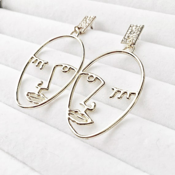 Minimalist face best sale earrings