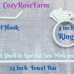 May include: A set of conch shell bathroom fixtures in a sea mist finish on white. Includes a 24-inch towel bar, a 4-inch ring, and a TP holder/towel hook. The fixtures are mounted on a light gray wooden background.