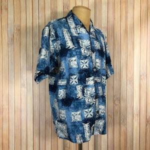 May include: A blue and white patterned short-sleeved button-up shirt with a relaxed fit.