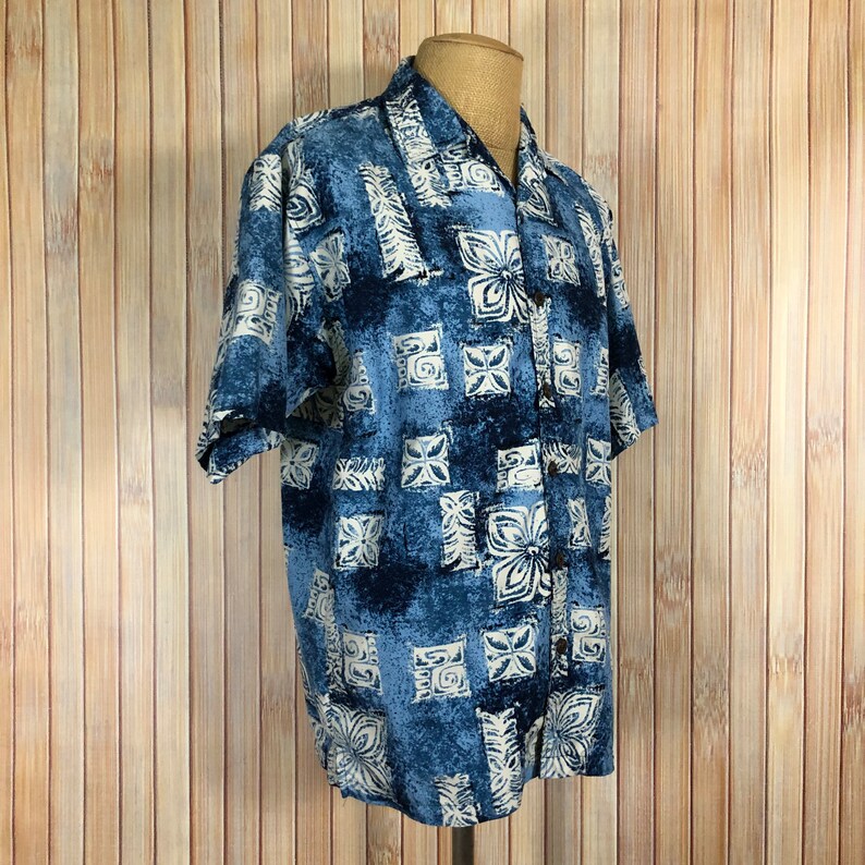 May include: A blue and white patterned short-sleeved button-up shirt with a relaxed fit.