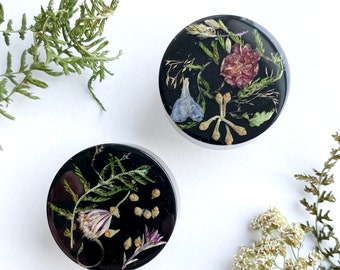 Abstract black cabinet knobs with different plants & flowers