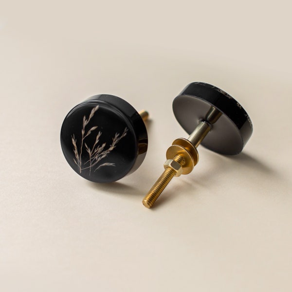 Minimalistic black furniture knob with summer grass