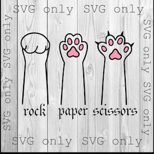 May include: A black and white graphic depicting the game rock, paper, scissors, with each hand gesture represented by a cat paw. The words "rock", "paper", and "scissors" are below each paw. The words "SVG only" are around the image.