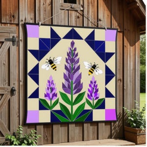 May include: A square wall hanging featuring a geometric quilt-style pattern with a central lavender flower design, two bees with yellow and black striped bodies, and a border of dark blue triangles and light purple squares on a cream background.