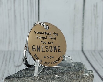 Sometimes you forget that you are AWESOME so this is your reminder Keychain with a message on it on a backing card in a cellophane Sleeve