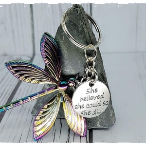 Dragon Fly Tempered Color with a message &#39;she believed she could so she did&#39; Keychain on a backing card in a sealed cellophane Sleeve