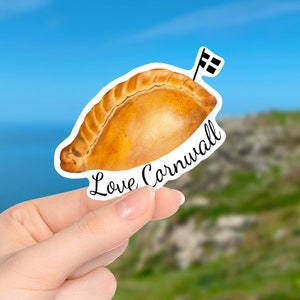 May include: A sticker of a Cornish pasty with a chequered flag on top and the text "Love Cornwall".