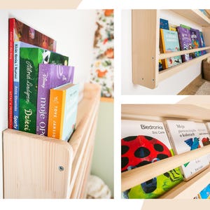 May include: A light-colored wooden wall-mounted bookshelf featuring a horizontal front rail to hold books in place. The shelf is filled with various children's books with colorful spines and covers, including titles like Biedronka and Moja pierwsza książka.
