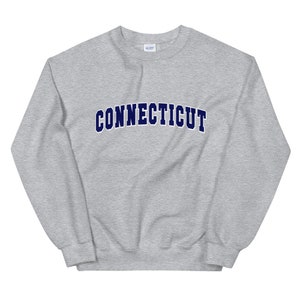 May include: Gray sweatshirt with the word "CONNECTICUT" in navy blue letters.