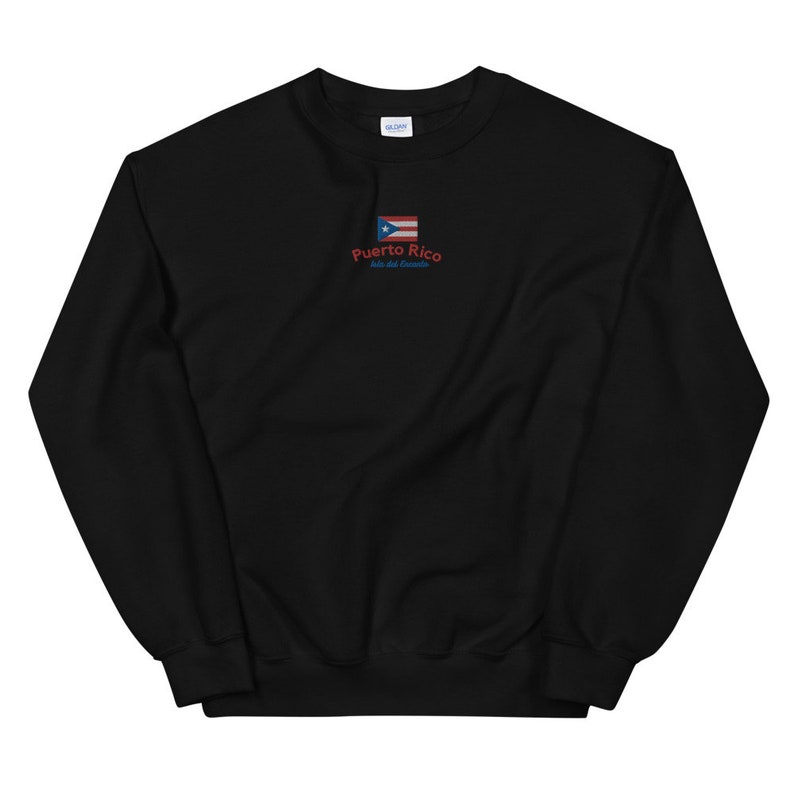 May include: Black sweatshirt with a red and blue Puerto Rican flag and the text "Puerto Rico, Isla del Encanto" embroidered on the front.