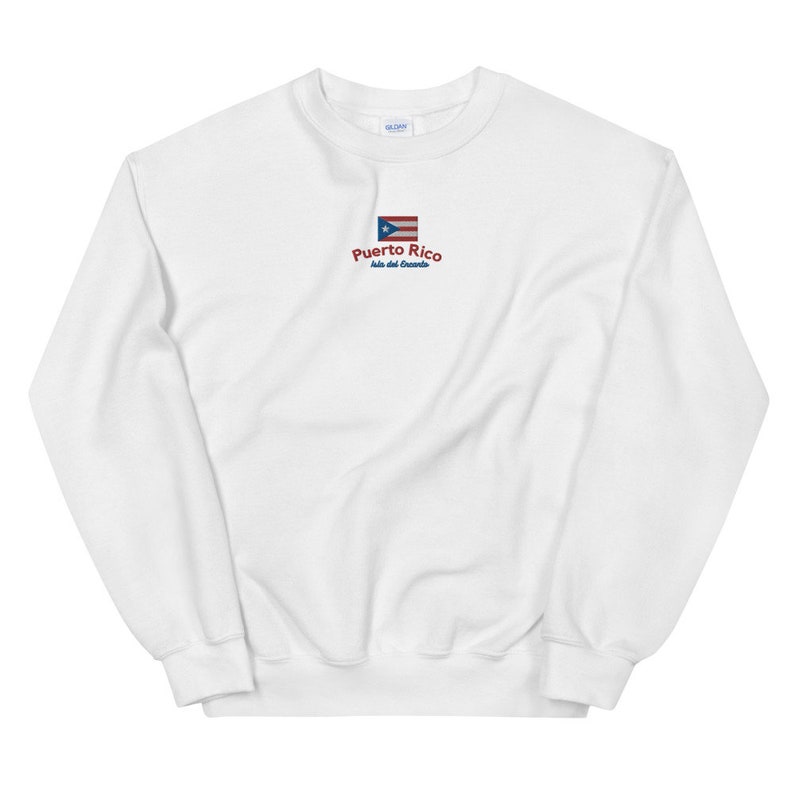 May include: White sweatshirt with a red embroidered Puerto Rico flag and the text "Puerto Rico, Isla del Encanto".