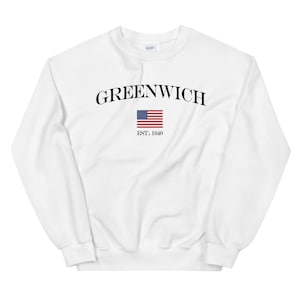 May include: White sweatshirt with black text that reads "GREENWICH EST. 1640" and a small American flag.