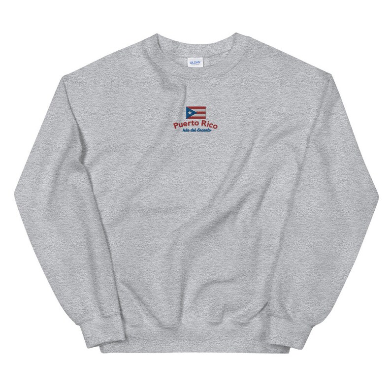 May include: A gray sweatshirt with a small embroidered image of the Puerto Rican flag and the text "Puerto Rico, Isla del Encanto".