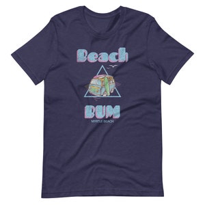 May include: A navy blue t-shirt with a vintage-style graphic of a blue van with a surfboard, a triangle, and the text "Beach Bum Myrtle Beach".
