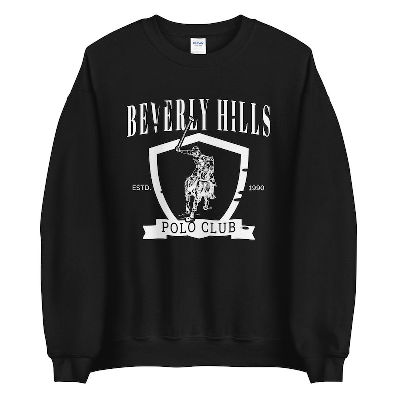 May include: Black sweatshirt with a white graphic of a polo player on a horse, a shield, and the text "Beverly Hills Polo Club" with "Estd. 1990" underneath.