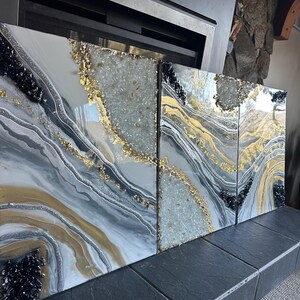 May include: Three abstract art panels with a white, gray, and gold background. The panels feature black and white glitter, gold leaf, and clear quartz crystals.