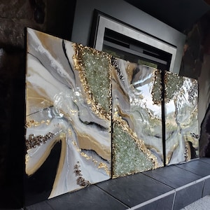 May include: Three abstract art panels with a white, black, and gold background with green and gold glitter accents.