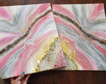 May include: Two abstract paintings with pink, gray, and gold swirls and glitter. The paintings are on canvas and have a modern, contemporary style.