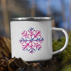 May include: White enamel mug with a pink and blue plaid snowflake design.