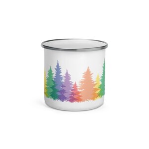 May include: A white enamel mug with a rainbow colored forest silhouette design. The trees are outlined in green, blue, purple, pink, orange, and yellow.