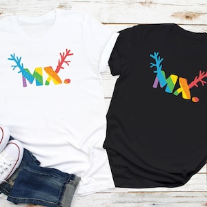 May include: Two t-shirts featuring a rainbow design that reads "MX." The t-shirts are white and black.