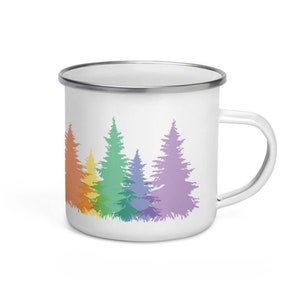 May include: White enamel mug with a rainbow-colored silhouette of a row of pine trees.