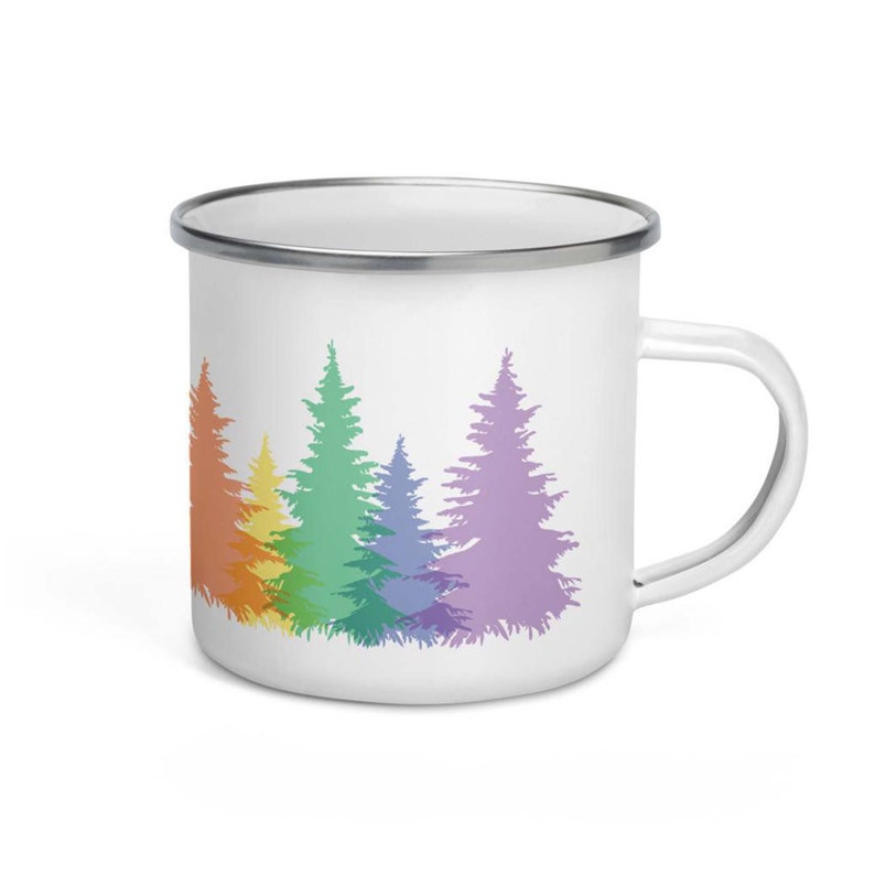 May include: White enamel mug with a rainbow-colored silhouette of a row of pine trees.