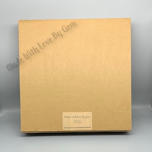 May include: A brown cardboard box with a label that reads "Made with love by Gem" and a website address.