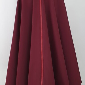 May include: A burgundy skirt with a red zipper down the back.