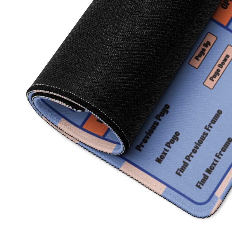 May include: Rolled-up blue and peach mousepad with black textured backing. The mousepad has a light blue surface with peach and orange geometric shapes and text labels including "Page Up" and "Page Down".