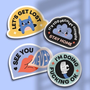 May include: Four colorful stickers with humorous messages. The first sticker is yellow with a blue cat and the text "Let's Get Lost". The second sticker is black with a blue cloud and the text "It's Too Peopley Outside Stay Home". The third sticker is blue with a red lip and the text "See You Never". The fourth sticker is green with a black hand and the text "I'm Doing Fucking Ok".