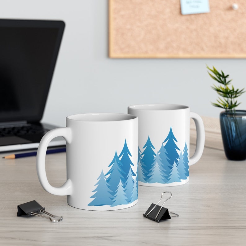 Pine tree forest silhouette coffee mug with minimalist blue fir and evergreen tree design printed on a BPA free and Lead Free 11 oz coffee Mug, ideal gift for the nature lover