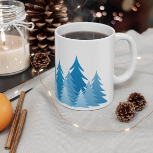 Pine tree forest silhouette coffee mug with minimalist blue fir and evergreen tree design printed on a BPA free and Lead Free 11 oz coffee Mug, ideal gift for the nature lover