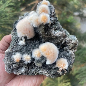 Orange mesolite ball on black matrix
