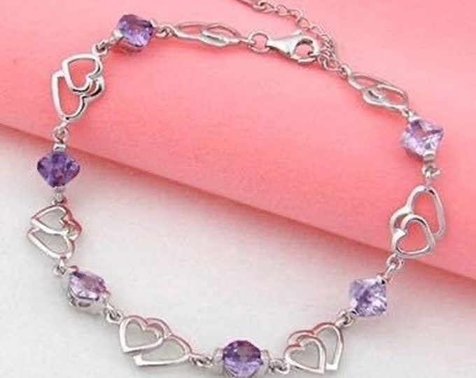 Silver and cubic zirconia heart link bracelet.