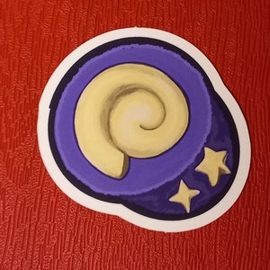 May include: A purple and yellow sticker with a spiral shell design and two gold stars.