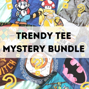 May include: A pile of t-shirts with various cartoon characters, including Mario, Homer Simpson, and Batman. The shirts are arranged on a light blue background with the text "TRENDY TEE MYSTERY BUNDLE".