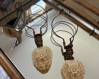 Pair of lamp finials.  Made of carved ivory I believe.  Quite the statement pieces.  Circa 1930s. 6” x 2.5” wide.  Brass