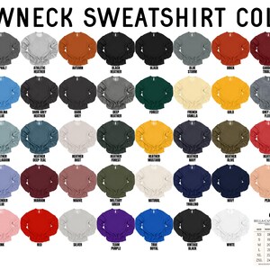 K&ouml;nnte beinhalten: Eine Tabelle mit 40 verschiedenen Farboptionen f&uuml;r Rundhals-Sweatshirts. Die Farben sind in Reihen und Spalten angeordnet, wobei jede Farbe durch einen kleinen Stoffmuster dargestellt wird. Die Tabelle enth&auml;lt auch eine Gr&ouml;&szlig;entabelle mit Ma&szlig;en in Zoll.